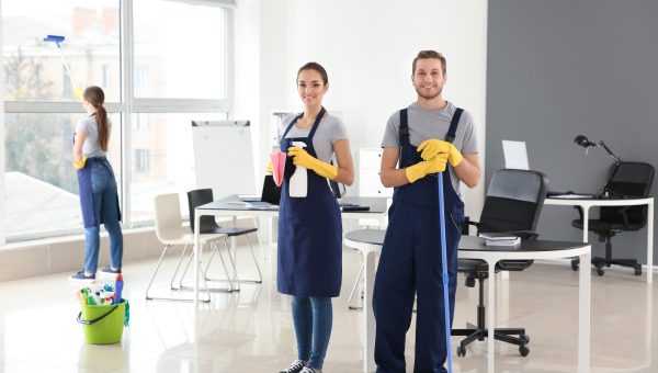 Team of janitors cleaning office